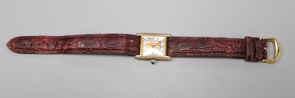A ladys 925 gilt Cartier Vermeil Tank quartz rectangular wrist watch, with three colour Roman dial, on Cartier leather strap,
